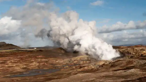 A powerful steam vent is blowing an immense white cloud